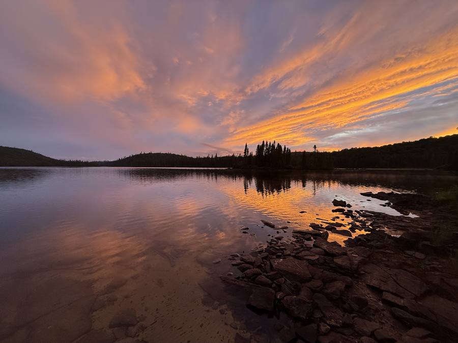 Orange sunset over the lake at the first camp.