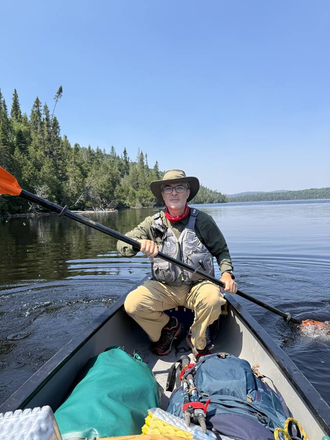Stan paddling on the calm blue lake on the last day.