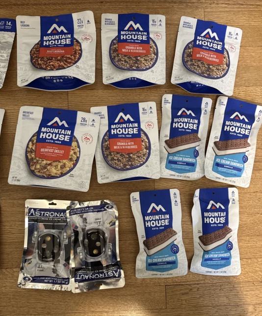 Mountain House freeze-dried meal pouches: Granola with Milk and Blueberries, Breakfast Skillet, and Ice Cream Sandwiches.